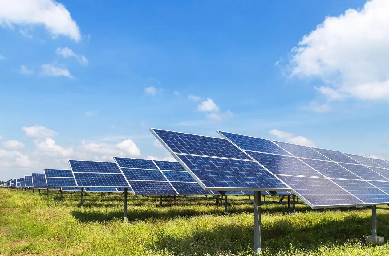 Solar panels supported by screw piles in a commercial field.